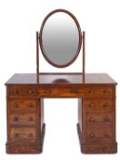 A Victorian walnut pedestal dressing table, with oval swing frame mirrors superstructure,