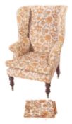 A Victorian stained beech wing frame armchair, fully upholstered in floral design beige fabric,