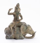 An Indian bronze figure of a deity seated on the back of an elephant,