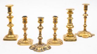 A collection of antique brass candlesticks; comprising a pair of Dutch examples, early 18th century,