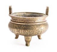 A Chinese polished bronze tripod censer with flattened loop handles, engraved with Shou medallions,
