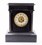 A black slate mantel clock having an eight-day duration movement with an anchor escapement and