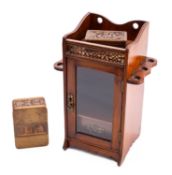An Edwardian mahogany smoker's cabinet, early 20th century; with galleried top above a glazed door,