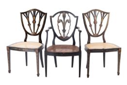 A pair of painted and caned side chairs in George III Hepplewhite style,