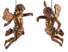 A pair of Continental carved and giltwood models of cherubs,