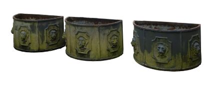 A set of three cast iron planters in Queen Anne taste,