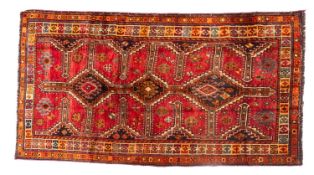 A Lori rug, the rose field with triple stepped and pointed lozenge indigo medallions,