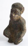 A Continental gilt bronze model of a seated ape, early 20th century; 6cm high,
