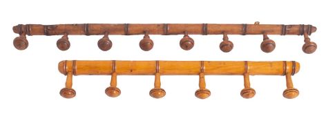 A sycamore simulated bamboo wall mounted coat rail, with eight circular pegs,
