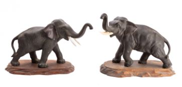 A pair of Japanese bronze elephants, signed Genryusai Seiya,