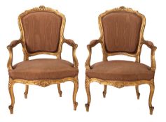 A pair of Continental carved giltwood fauteuils in the Louis XV manner,