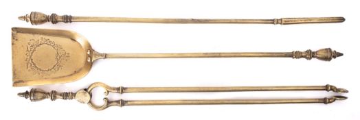 A set of three brass fire irons in George III style, 19th century; comprising shovel,