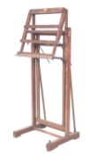 An oak studio easel by Clifford Milburn & Co,