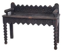 A Victorian carved oak hall bench,