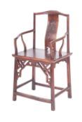 A Chinese carved and stained hardwood elbow chair,