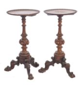 A pair of Victorian style carved walnut circular occasional tables,