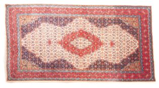 A Sarouk rug, the ivory shaped field with a central rose shaped lozenge pole medallion,