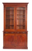A Victorian mahogany bookcase, the upper part with a moulded cornice,