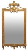 A carved and giltwood framed wall mirror in Louis XVI style,