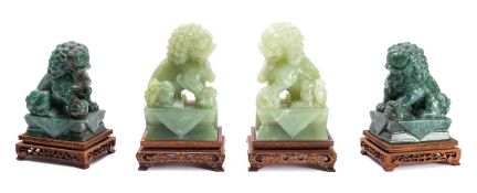Two pairs of Chinese green hardstone carvings of Buddhist lions, late 20th century,