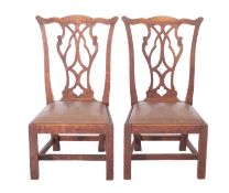 A pair of Scottish Edwardian oak 'Gossip Chairs'