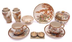 A group of Satsuma pottery, comprising a small pair of jars, a pair of cups and saucers,