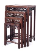 A set of Chinese Hua Li wood quartetto tables, with rectangular tops and pierced cloud band friezes,