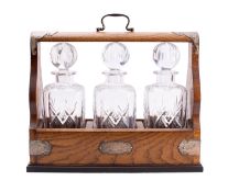 An Elizabeth II three bottle tantalus by A.C, Birmingham 2000
