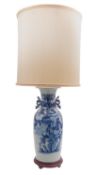 A large Chinese blue and white vase/lamp painted with peacocks, foliage and rockwork,