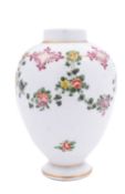A Champion's Bristol tea canister of ovoid form painted with a continuous floral garland suspended