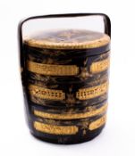 A Chinese black and gold lacquered three-tier rice basket decorated with birds, flowers and foliage,