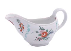 A Champion's Bristol sauceboat of ogee form with moulded scrollwork borders,
