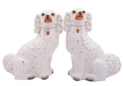 A pair of large Staffordshire pottery spaniels with flesh coloured muzzles and gilt collars and