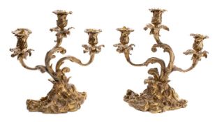 A pair of gilt bronze three light candelabra in Rococo style,