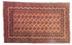 A Turkoman rug, the brick red field with three rows of quartered octagons,