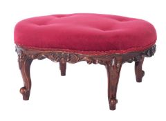 A carved walnut oval low stool in Victorian style,