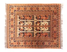 A Turkoman rug, the panelled field with geometric boteh and stylised birds in indigo,