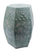 A Chinese celadon-glazed octagonal garden seat decorated in white relief with blossom,