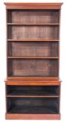 A late 19th Century mahogany upright open bookcase, in two sections, with a moulded cornice,