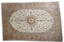 A Kashan carpet, the ivory cartouche field with a central circular pole medallion,