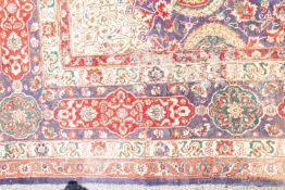 A Kashmiri carpet, the indigo field with a central ivory radiating flowerhead medallion,
