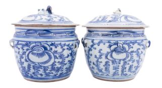 A pair of Chinese provincial blue and white storage jars and covers painted with peonies and