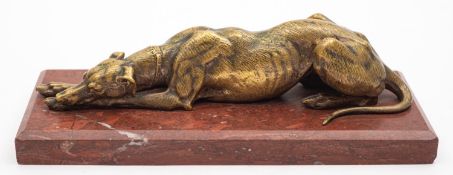A bronze and marble mounted model of a recumbent greyhound