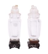 A pair of small Chinese glass vases and covers in imitation of rock crystal,