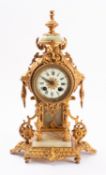 A mid-Victorian gilt-metal and alabaster mantel clock the eight-day duration movement striking the