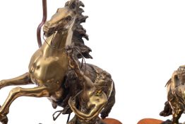 A pair of Continental patinated bronze models of the Marly Horses,