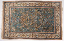 An Isfahan rug, the pastel blue field with an all over design of palmettes, birds,