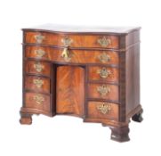 A 19th Century mahogany kneehole chest of serpentine outline in the Chippendale manner,