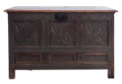 An 18th century oak and later carved dower chest; with hinged top.