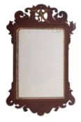 A late 19th Century mahogany and partly gilt fret carved mirror, in the Georgian manner,